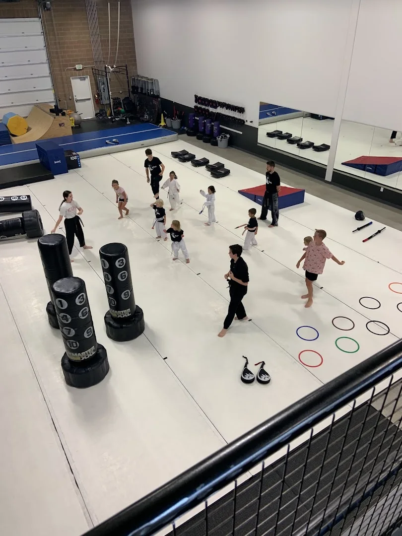 Looking down on a class spread across the huge white mat at Kona Karate